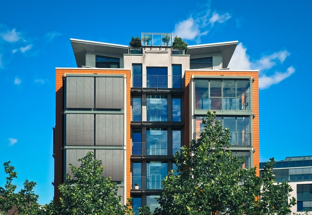 Modern apartment building with balconies and a roof terrace