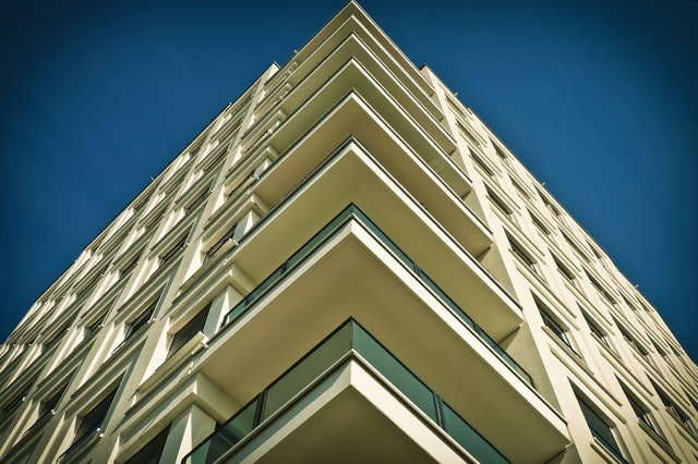 Residential building photographed from below, with balconies on every floor